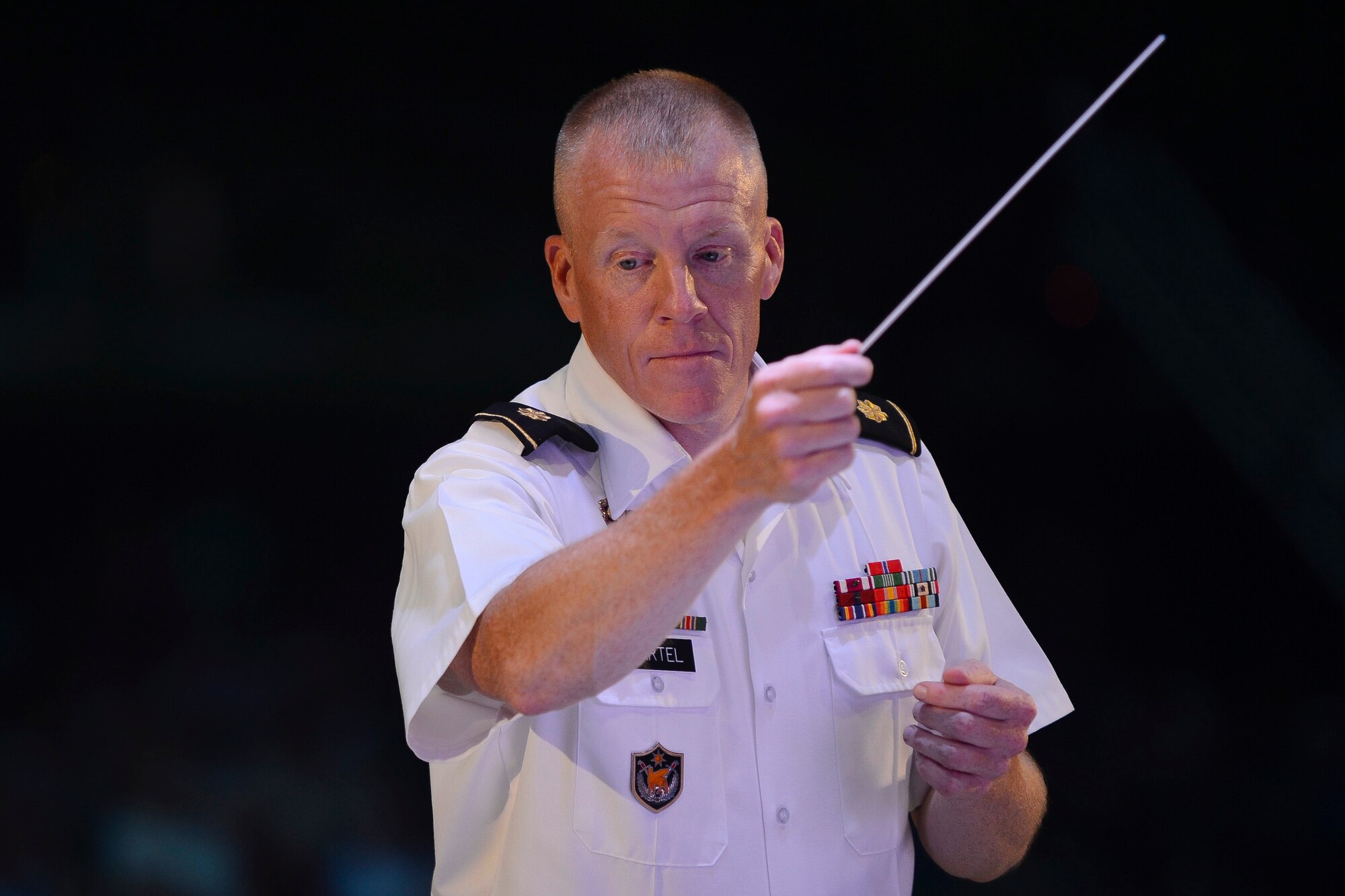 U.S. Army Maj. Randy Bartel, Training and Doctrine Command Band commander, conducts a song during the “Music Under the Stars” season finale concert at Joint Base Langley-Eustis, Va., Aug. 31, 2017.