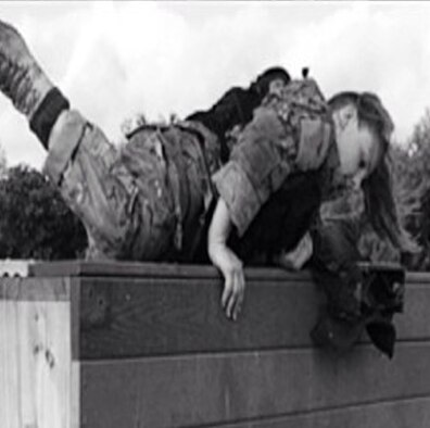 Capt. Kaci Dixon moves through an obstacle course during the Women in Service Review in June 2015 at Lackland Air Force Base, Texas. She was wearing a 30-pound vest and carrying a 90-pound ruck to simulate gear. (Courtesy photo)