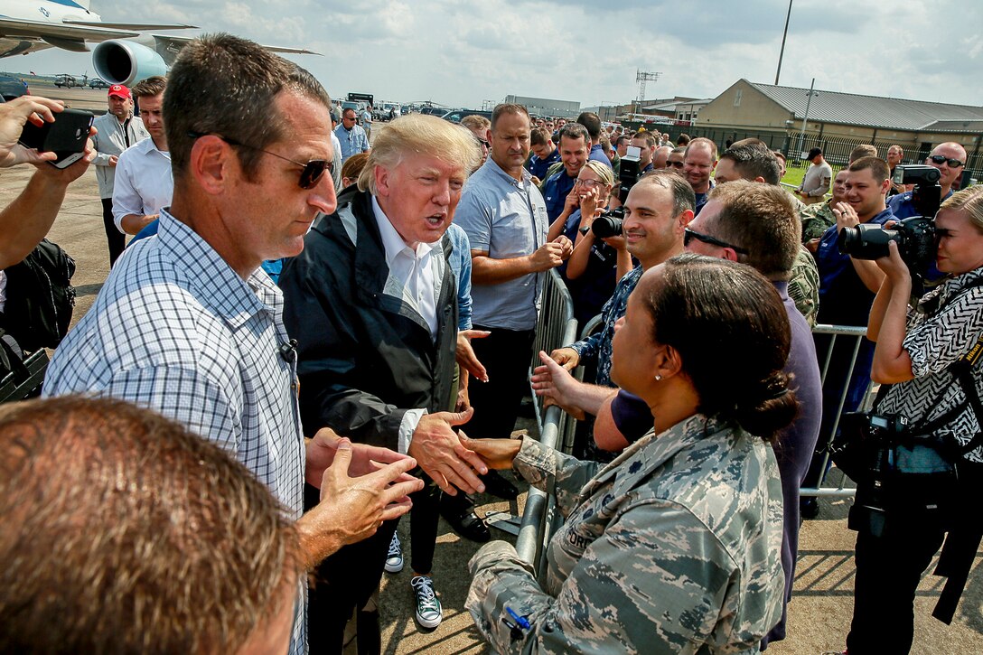 President Donald J. Trump reaches to shake the hand of a service member.