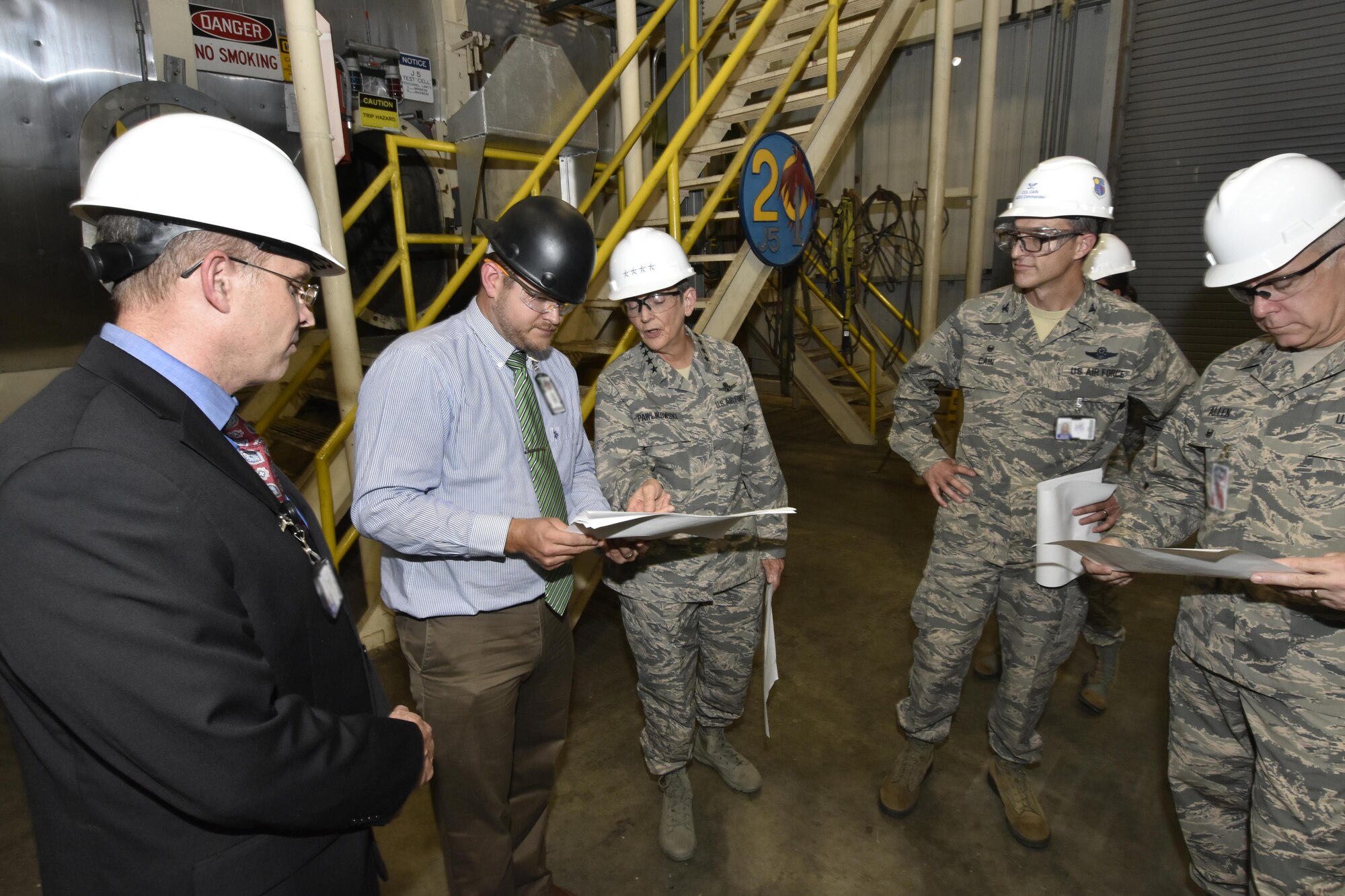 Gen. Ellen M. Pawlikowski, Air Force Materiel Command commander (center), and Col. Scott Cain, Arnold Engineering Development Complex commander (right of center), receive a facility briefing and tour of the AEDC J5 Rocket Motor Test Facility by AEDC staff members Aug. 22, 2017. (U.S. Air Force photo/Rick Goodfriend) (This image was manipulated by obscuring badges for security purposes.)