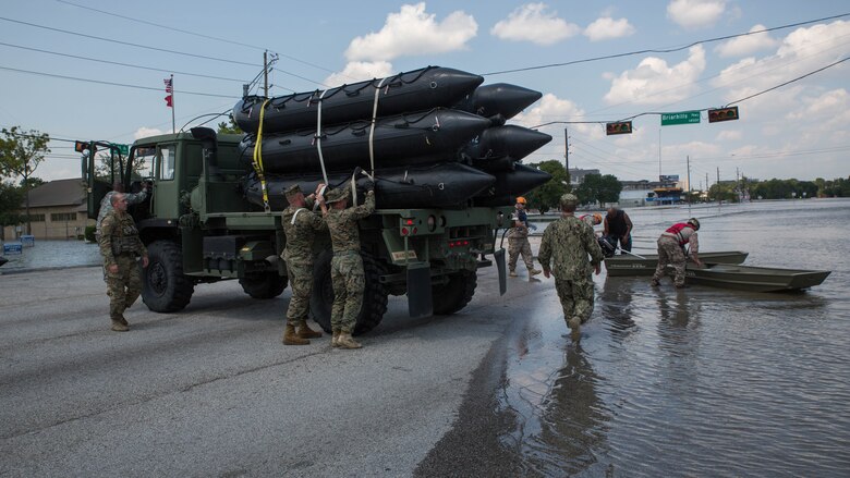 U.S. Marines with Charlie Company, 4th Reconnaissance Battalion, 4th Marine Division, Marine Forces Reserve, unload their Marine Corps F470 Zodiacs Combat Rubber Raiding crafts on to a flooded street in Houston, Texas, Aug. 31, 2017. Marines from Charlie Company assisted rescue effort in wake of Hurricane Harvey by providing Zodiacs and personal to local law enforcement.