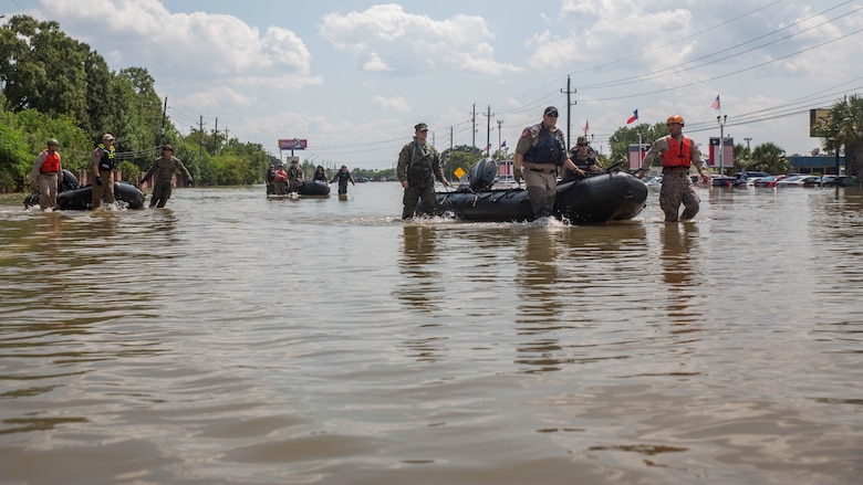 Marines with Charlie Company, 4th Reconnaissance Battalion, 4th Marine Division, Marine Forces Reserve, along with members of the Texas Highway Patrol and Texas State Guard, pull Marine Corps F470 Zodiacs Combat Rubber Raiding crafts through a flooded street in Houston, Texas, Aug. 31, 2017. Marines from Charlie Company assisted Texas Highway Patrolmen during rescue effort in wake of Hurricane Harvey which landed Aug. 25, 2017, and displaced over 30,000 people.