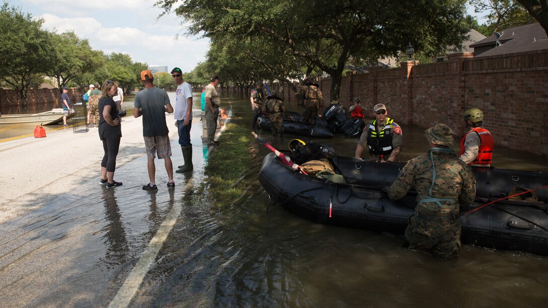 Marines with Charlie Company, 4th Reconnaissance Battalion, 4th Marine Division, Marine Forces Reserve, along with members of the Texas Highway Patrol and Texas State Guard, pull Marine Corps F470 Zodiacs Combat Rubber Raiding crafts through a flooded street in Houston, Texas, Aug. 31, 2017. Hurricane Harvey landed Aug. 25, 2017, flooding thousands of homes and displaced over 30,000 people.
