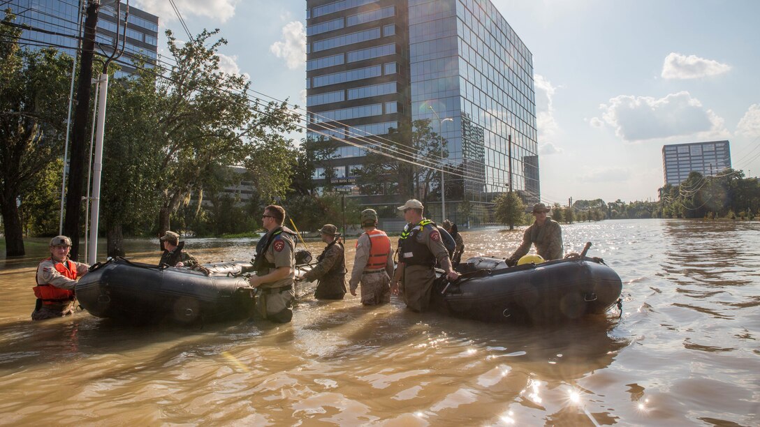 Marines with Charlie Company, 4th Reconnaissance Battalion, 4th Marine Division, Marine Forces Reserve, along with members of the Texas Highway Patrol and Texas State Guard, pull Marine Corps F470 Zodiacs Combat Rubber Raiding crafts through a flooded street in Houston, Texas, Aug. 31, 2017. Marines from Charlie Company assisted rescue effort in wake of Hurricane Harvey by providing Zodiacs and personal to local law enforcement.