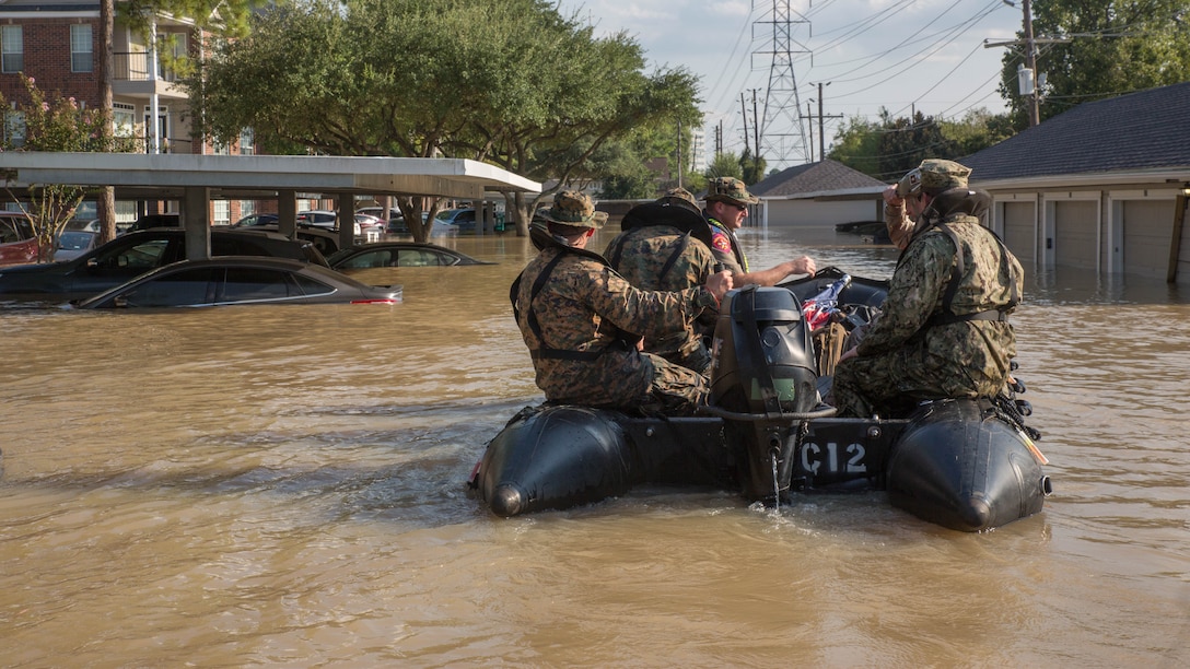 Marines with Charlie Company, 4th Reconnaissance Battalion, 4th Marine Division, Marine Forces Reserve, along with a member of the Texas Highway Patrol and Texas State Guard, navigate through a flooded parking lot in Houston, Texas, Aug. 31, 2017. Marines from Charlie Company assisted rescue effort in wake of Hurricane Harvey by providing Zodiacs and personal to local law enforcement.