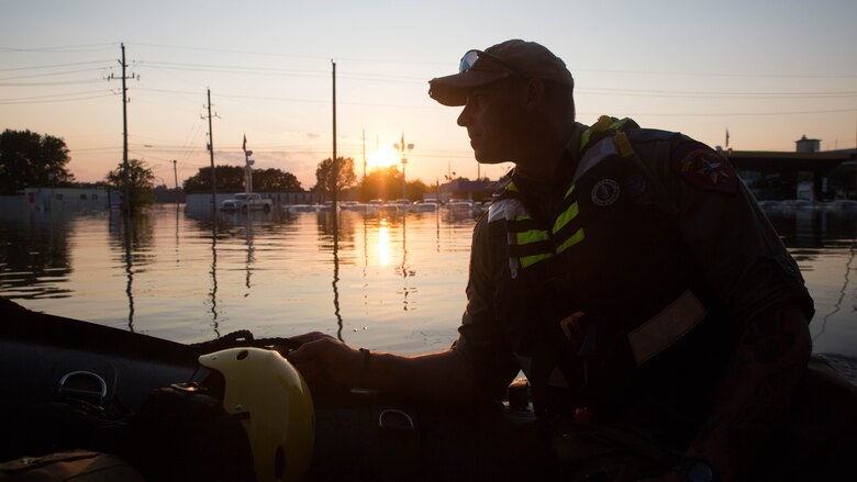 William Boston, a trooper with the Texas Highway Patrol, looks out over a flooded street aboard a Marine Corps F470 Zodiacs Combat Rubber Raiding crafts in Houston, Texas, Aug. 31, 2017. Marines from Charlie Company, 4th Reconnaissance Battalion, 4th Marine Division, assisted rescue effort in wake of Hurricane Harvey by providing Zodiacs and personal to local law enforcement.