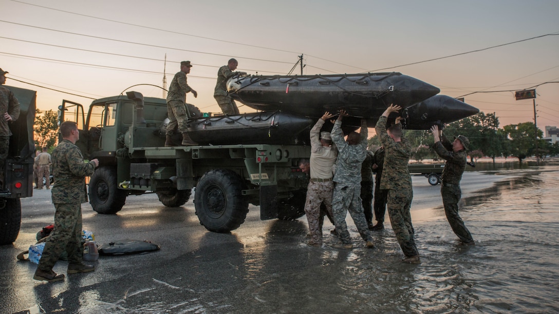 Marines with Charlie Company, 4th Reconnaissance Battalion, 4th Marine Division, Marine Forces Reserve, Texas State Guardsmen and members of the Texas National Guard, load a Marine Corps F470 Zodiac Combat Rubber Raiding crafts on to an Army 1078 A1 Truck after completing rescue mission in Houston, Texas, Aug. 31, 2017. Marines from Charlie Company assisted rescue effort in wake of Hurricane Harvey by providing Zodiacs and personal to local law enforcement.