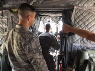 Firefighters from the 502nd Civil Engineer Squadron conduct familiarization training on a CH-47 Chinook at JBSA-Suguin Auxiliary Airfield Sep. 5, 2017.  The Airmen participated in the training to better prepare themselves to deal with rotary-wing aircraft in the event of an emergency. (U.S. Air Force photo by Dan Hawkins)