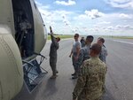 Firefighters from the 502nd Civil Engineer Squadron follow along with a 1st Armored Division Combat Aviation Brigade Soldier during familiarization training on a CH-47 Chinook at Joint Base San Antonio-Seguin Auxiliary Airfield Sept. 5, 2017. The 1st AD Soldiers are stationed at Fort Bliss, Texas and were loading supplies to deliver to Beaumont, Texas in the wake of Hurricane Harvey. (U.S. Air Force photo by Dan Hawkins)