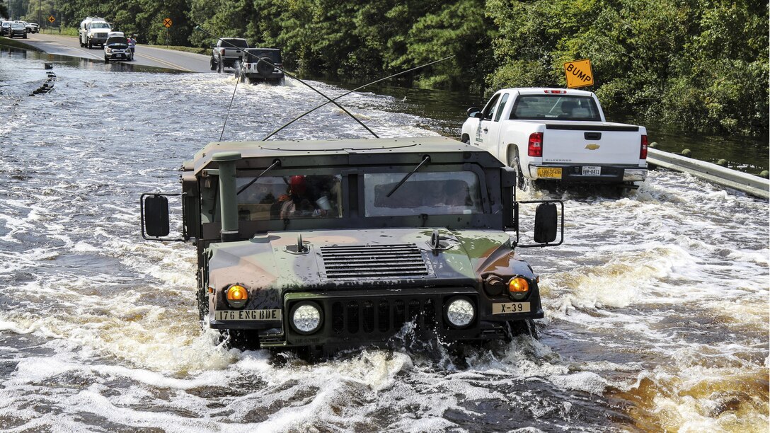 Soldiers drive on flooded roads as they continue rescue missions.