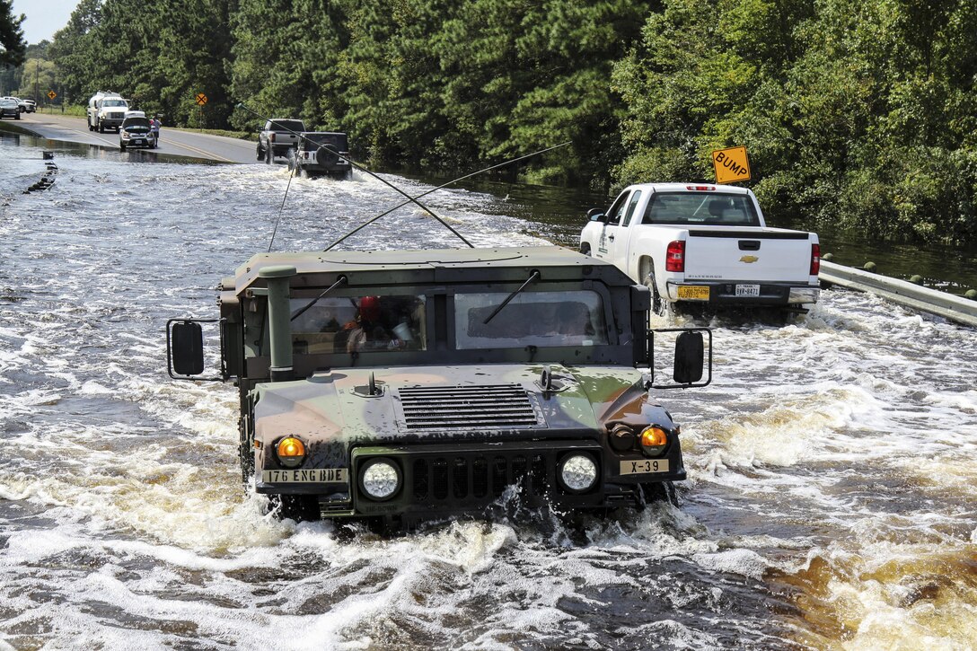 Soldiers drive on flooded roads as they continue rescue missions.
