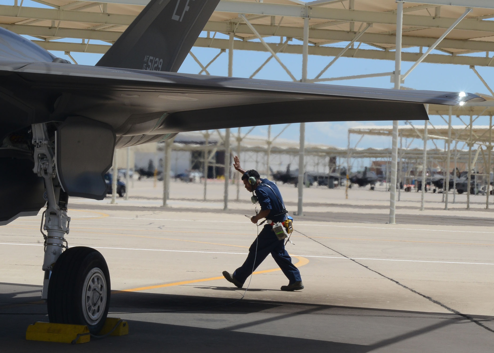 Airman 1st Class Eric Ruiz-Garcia, 63rd Aircraft Maintenance Unit crew chief, performs pre-flight inspections on an F-35A Lightning II at Luke Air Force Base, Ariz., Aug. 22, 2017. Ruiz-Garcia wore air sampling devices and thermal stress monitors during the launch and recovery of the F-35. The purpose of the test is to collect real time data of the air quality and the core temperatures of the maintainers during a launch. (U.S. Air Force photo/Senior Airman James Hensley)