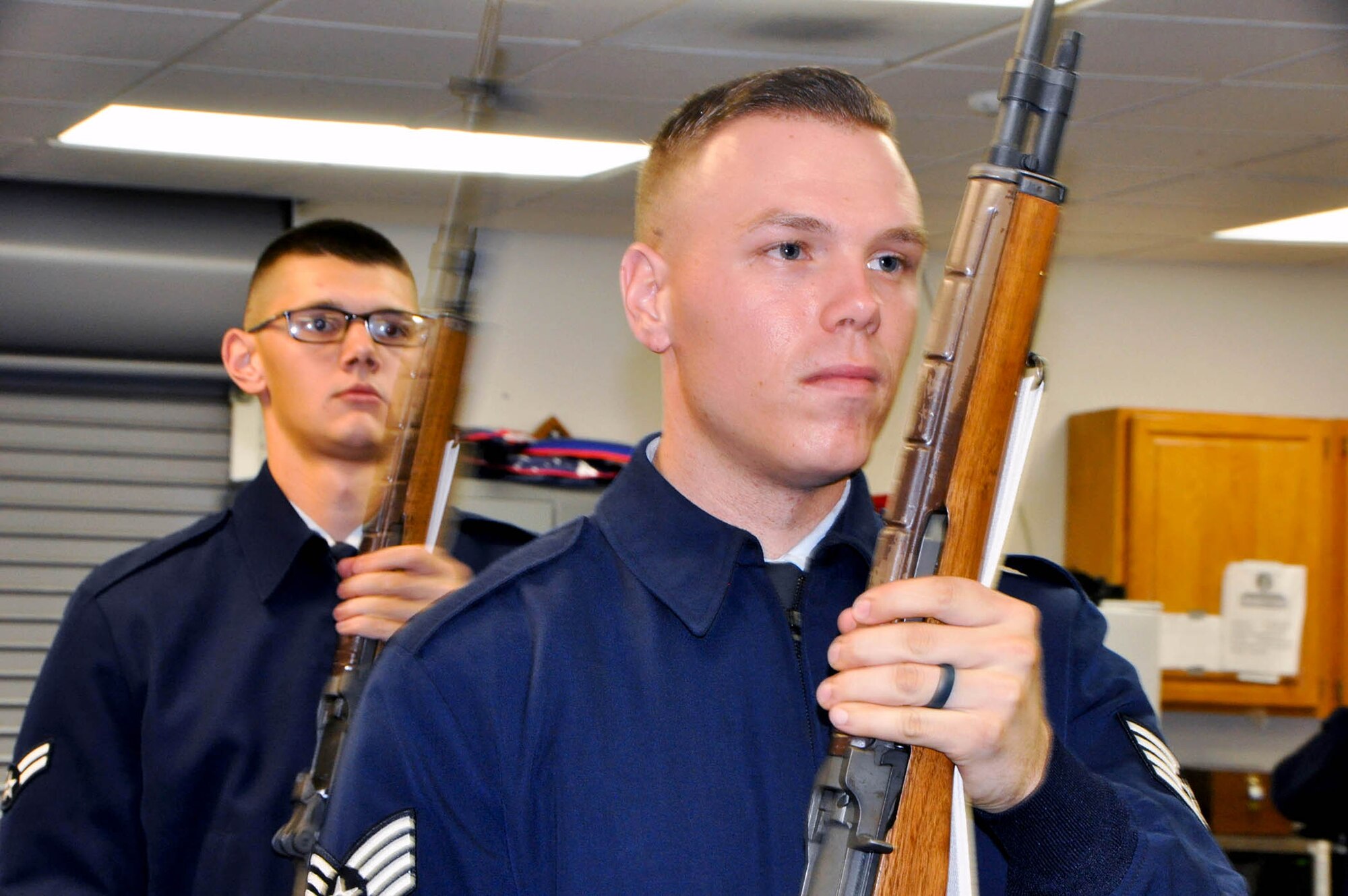 Airman 1st Class Russel H. Powell, (left) an active duty honor guardsman and Staff Sgt. Robert Langston, a reserve honor guardsman and trainer, practice drill movements to prepare themselves for a funeral service, June 23, 2017. (Technical Sgt. Cindy G. Alejandrez)