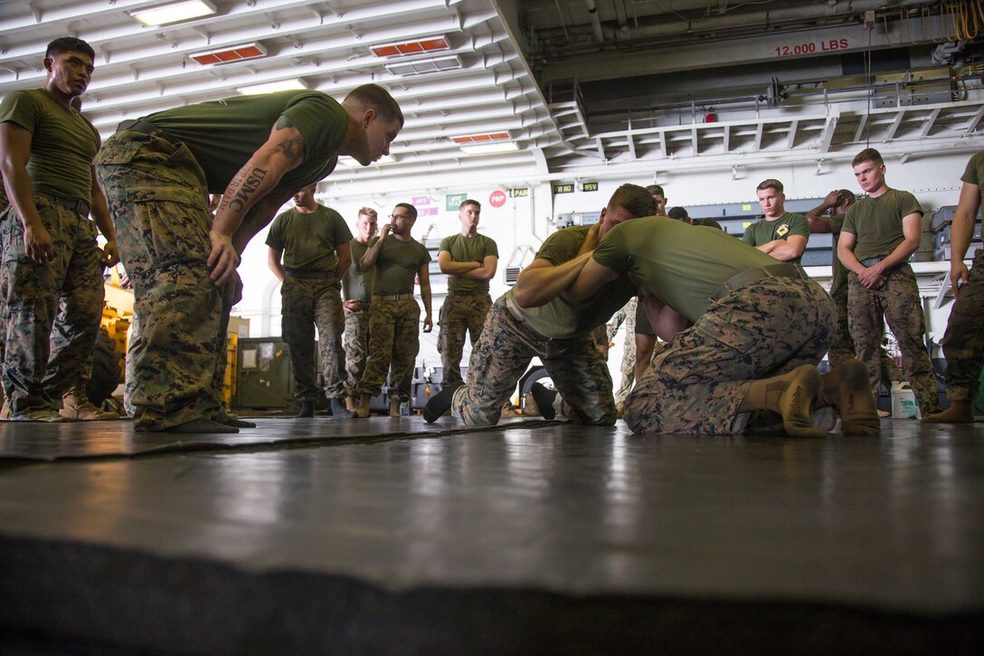 U.S. Marines with Company G, Battalion Landing Team 2nd Battalion, 6th Marine Regiment, 26th Marine Expeditionary Unit (MEU), grapple during Marine Corps Martial Arts Program training aboard the amphibious assault ship USS Kearsarge (LHD 3) in the Atlantic Ocean, Sep. 4, 2017. Approximately 690 Marines from the 26th MEU embarked aboard the amphibious assault ship as part of prudent measures in anticipation of future tasking to support hurricane relief efforts. (U.S. Marine Corps photo by Lance Cpl. Alexis C. Schneider)