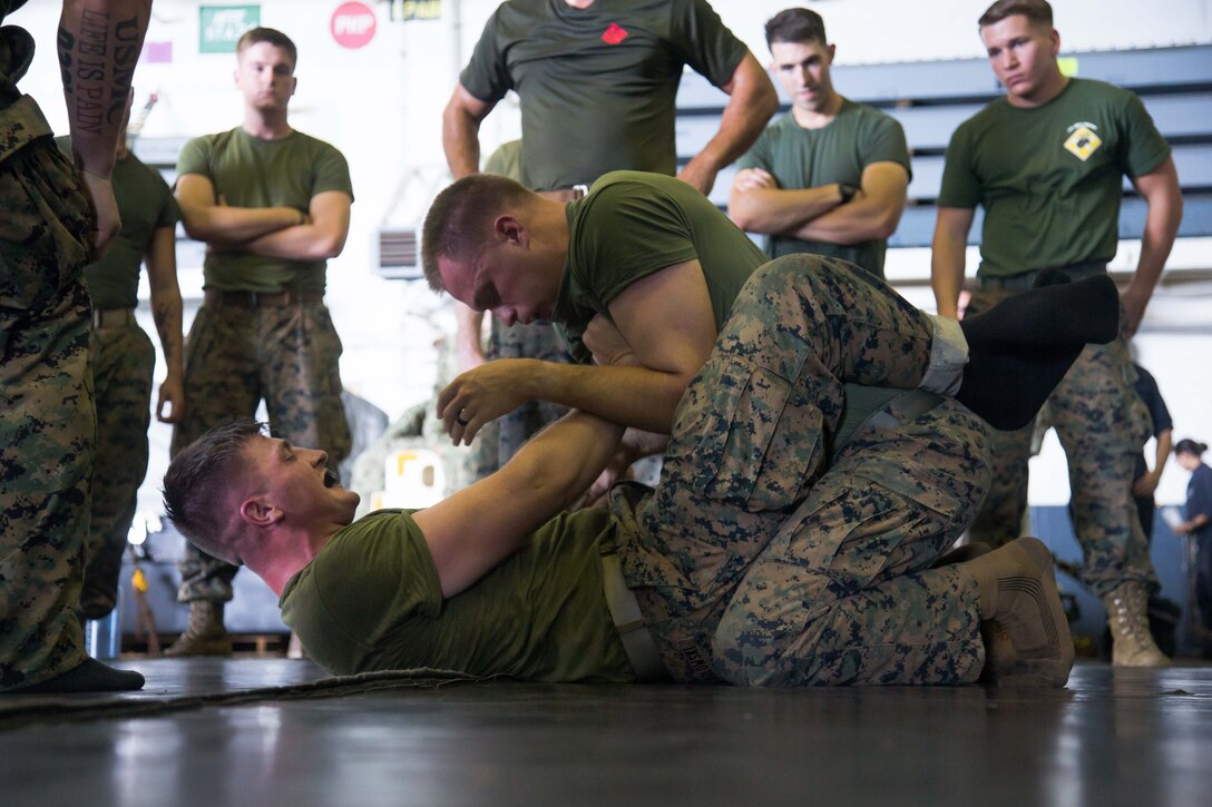 U.S. Marines with Company G, Battalion Landing Team, 2nd Battalion, 6th Marine Regiment, 26th Marine Expeditionary Unit (MEU), ground fight during Marine Corps Martial Arts Program training aboard the amphibious assault ship USS Kearsarge (LHD 3) in the Atlantic Ocean, Sep. 4, 2017. Approximately 690 Marines from the 26th MEU embarked aboard the amphibious assault ship as part of prudent measures in anticipation of future tasking to support hurricane relief efforts. (U.S. Marine Corps photo by Lance Cpl. Alexis C. Schneider)
