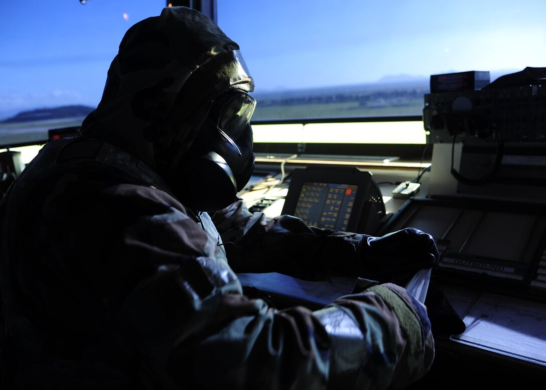 U.S. Air Force Staff Sgt. Jeff Howard, 8th Operations Support Squadron air traffic controller, dons his mission-oriented protective posture level four equipment as part of a regularly-scheduled operational readiness exercise, Beverly Pack 17-3, at Kunsan Air Base, Republic of Korea, Aug. 23, 2017. Air traffic control’s ability to carry out the duties of directing pilots in takeoff and landing, even in response to a chemical, biological, radiological or nuclear attack, plays a vital role in the 8th Fighter Wing’s abilities to defend the Korean peninsula. (U.S. Air Force photo by 2nd Lt Brittany Curry/Released)