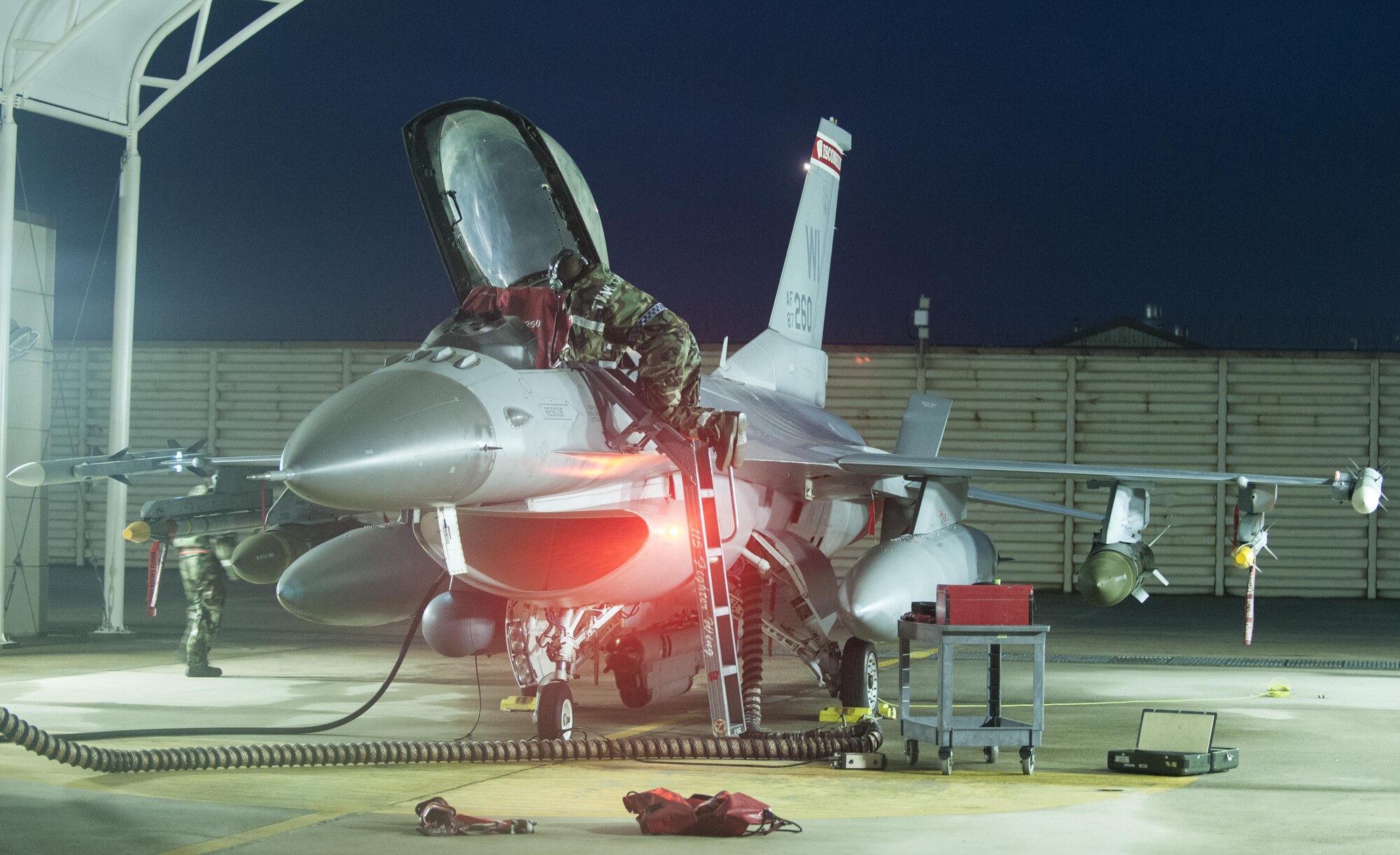 A U.S. Air Force crew chief, assigned to the 115th Fighter Wing, Wisconsin Air National Guard, performs maintenance on an F-16 Fighting Falcon at Kunsan Air Base, Republic of Korea, Aug. 22, 2017. The 115th Fighter Wing participated in a regularly-scheduled operational readiness exercise, Beverly Pack 17-3, as part of a Theater Security Package deployment to Kunsan. Pacific Air Forces TSPs signify a continued commitment to regional stability and security, while allowing units to train in the Pacific theater. (U.S. Air Force photo by 2nd Lt. Brittany Curry/Released)