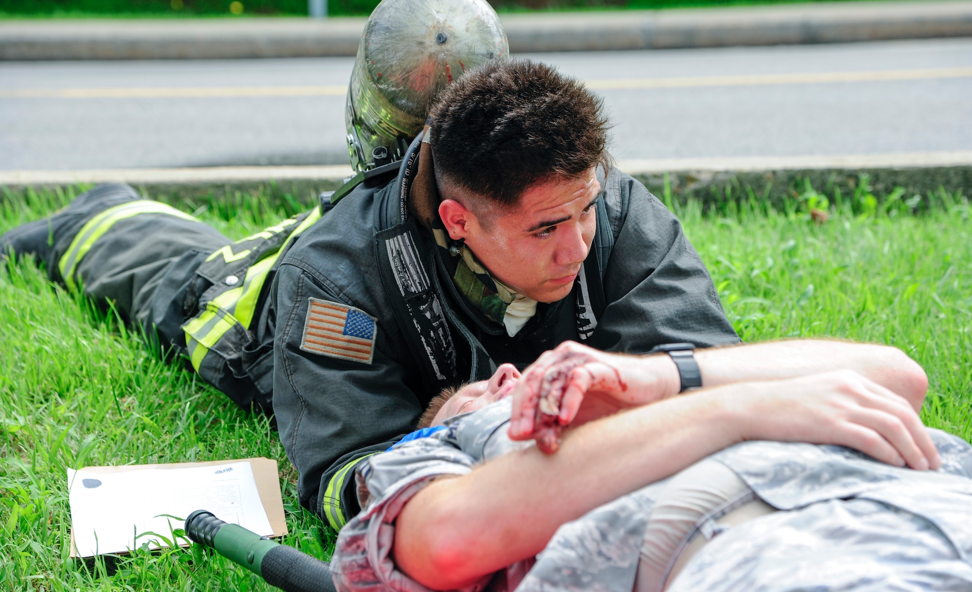 U.S. Air Force Senior Airman Omar Sanchez, 8th Civil Engineering Squadron firefighter, stabilizes the neck of a simulated car accident victim during training exercise Beverly Pack 17-3, at Kunsan Air Base, Republic of Korea, Aug. 22, 2017. During this exercise firefighters along with emergency medical technicians must arrive on the scene and tend to patients during high stress situations. (U.S. Air Force photo by Senior Airman Colby L. Hardin/Released)