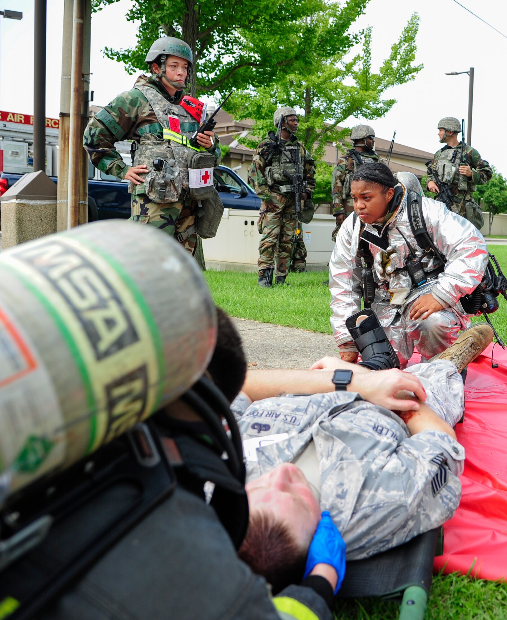 U.S. Air Force Airman 1st Class Rachel Walker-Zamora, 8th Civil Engineering Squadron firefighter, prepares to strap a simulated car accident victim to a medical litter during training exercise Beverly Pack 17-3, at Kunsan Air Base, Republic of Korea, Aug. 22, 2017. This exercises tested Kunsan first responders on time and effectiveness during a high stress environment. (U.S. Air Force photo by Senior Airman Colby L. Hardin/Released)