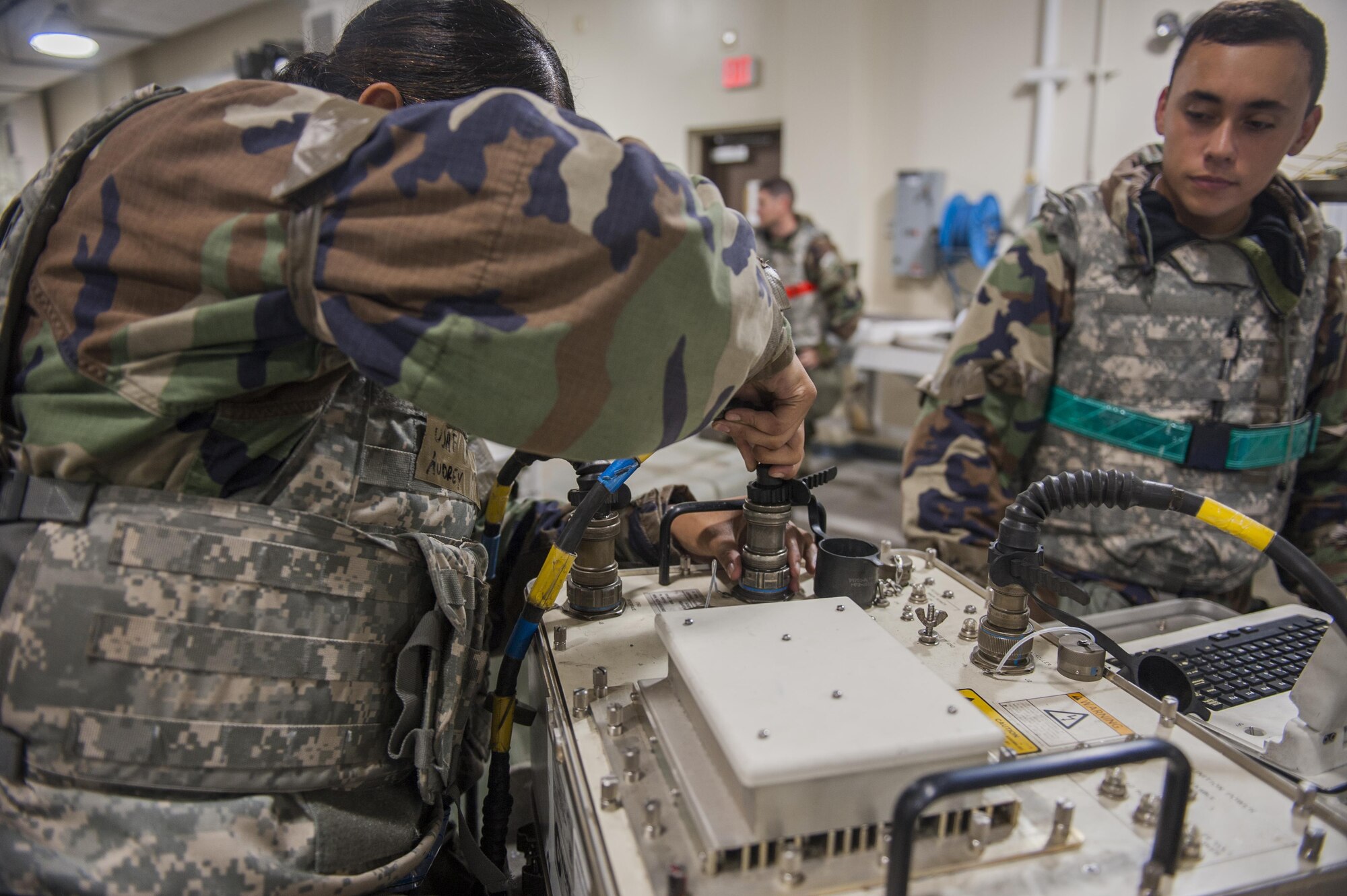 U.S. Air Force Airman 1st Class Audrey Naputi, 8th Munitions Squadron munitions support equipment maintainer crew chief, and Airman 1st Class Christopher Valencia, 8th Munitions Squadron conventional maintenance crew chief, assembles an AN/GYQ-79A Test Program Set, also known as Common Munitions Bit Reprograming Equipment, at Kunsan Air Base, Republic of Korea, Aug. 22, 2017. The CMBRE is used to test the tail fins on a bomb to ensure it is reading correctly when programed for a target.