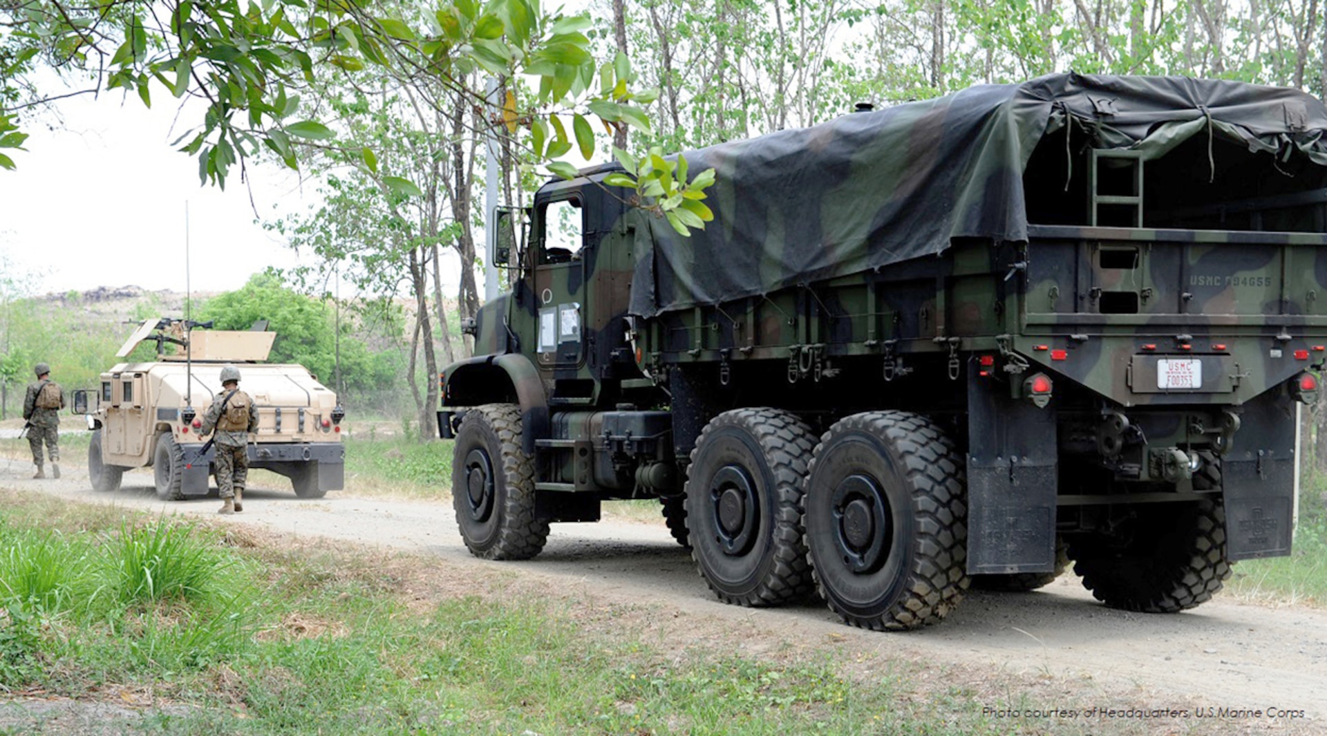 Marines with Combat Logistics Regiment 35, 3rd Marine Logistics Group, III Marine Expeditionary Force, ground guide a High Mobility Multipurpose Wheeled Vehicle and a Medium Tactical Vehicle Replacement prior to participating in a convoy field training exercise with Philippine Transportation and Maintenance Marines during Balikatan 2013 at Camp O’Donnell, Philippines.