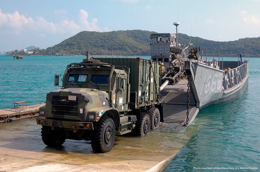 A seven-ton Medium Tactical Vehicle Replacement drives off Landing Craft Utility 1666 during Cobra Gold 2014, an annual multinational exercise to promote interoperability and training between the United States and Thailand.