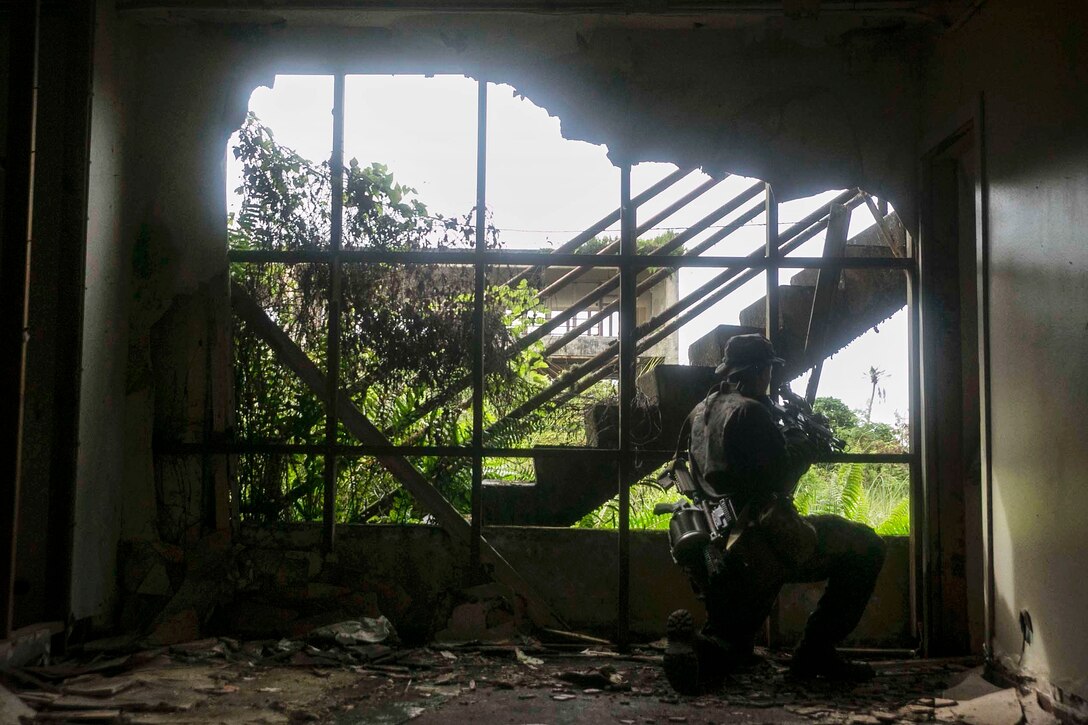 A Marine provides security after his team cleared an abandoned house
