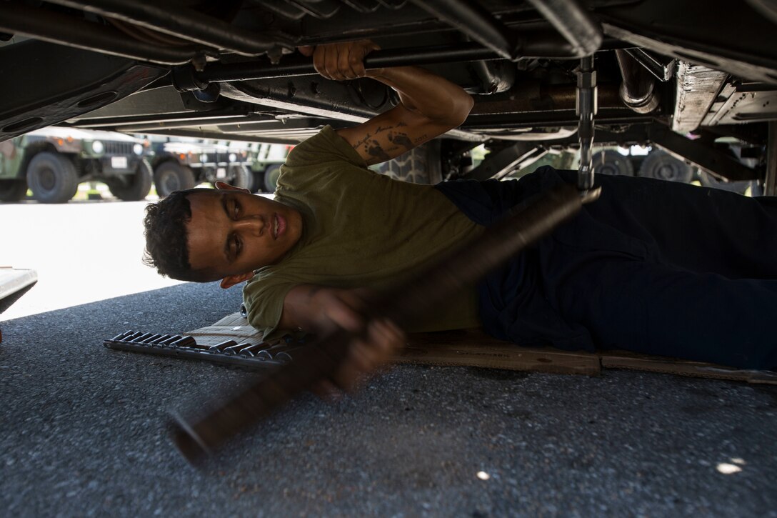 Lance Cpl. Isaiah J. Ali, a native of New York and a motor transport mechanic with III Marine Headquarters Group, III Marine Expeditionary Force, performs routine maintenance on the M1123 High Mobility Multipurpose Wheeled Vehicle (HMMWV) steering system on Camp Hansen, Okinawa, Japan, Sep. 6, 2017.