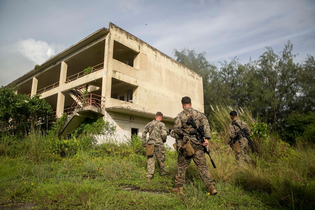 Marines with Battalion Landing Team, 3rd Battalion, 5th Marines, enter an abandoned building during Military Operations in Urbanized Terrain (MOUT) training at Andersen South Air Force Base, Guam, August 30, 2017. Marines with BLT 3/5 train regularly in different environments to maintain their readiness as the Ground Combat Element of the 31st Marine Expeditionary Unit. The 31st MEU partners with the Navy's Amphibious Squadron 11 to form the Bonhomme Richard Expeditionary Strike Group, providing a cohesive blue-green team capable of accomplishing a variety of missions across the Indo-Asia-Pacific region. (U.S. Marine Corps photo by Cpl. Amaia Unanue/Released)