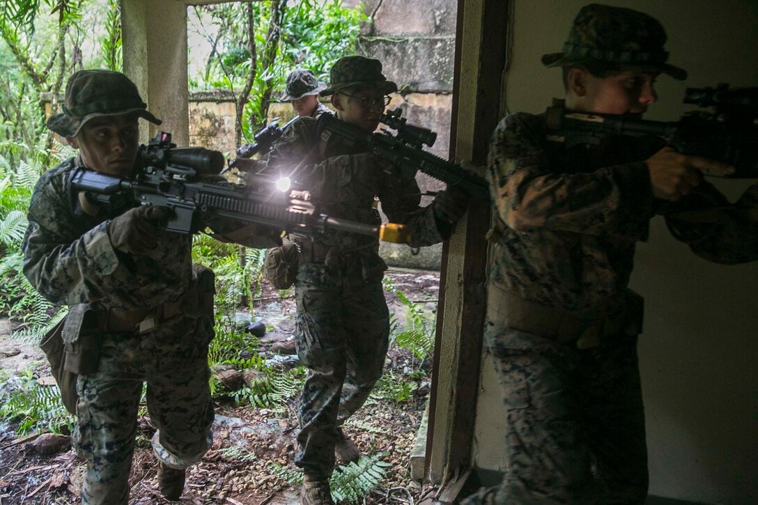 Marines with Battalion Landing Team, 3rd Battalion, 5th Marines, clear a room during Military Operations in Urbanized Terrain (MOUT) training at Andersen South Air Force Base, Guam, August 30, 2017. Marines with BLT 3/5 train regularly in different environments to maintain their readiness as the Ground Combat Element of the 31st Marine Expeditionary Unit. The 31st MEU partners with the Navy's Amphibious Squadron 11 to form the Bonhomme Richard Expeditionary Strike Group, providing a cohesive blue-green team capable of accomplishing a variety of missions across the Indo-Asia-Pacific region. (U.S. Marine Corps photo by Cpl. Amaia Unanue/Released)