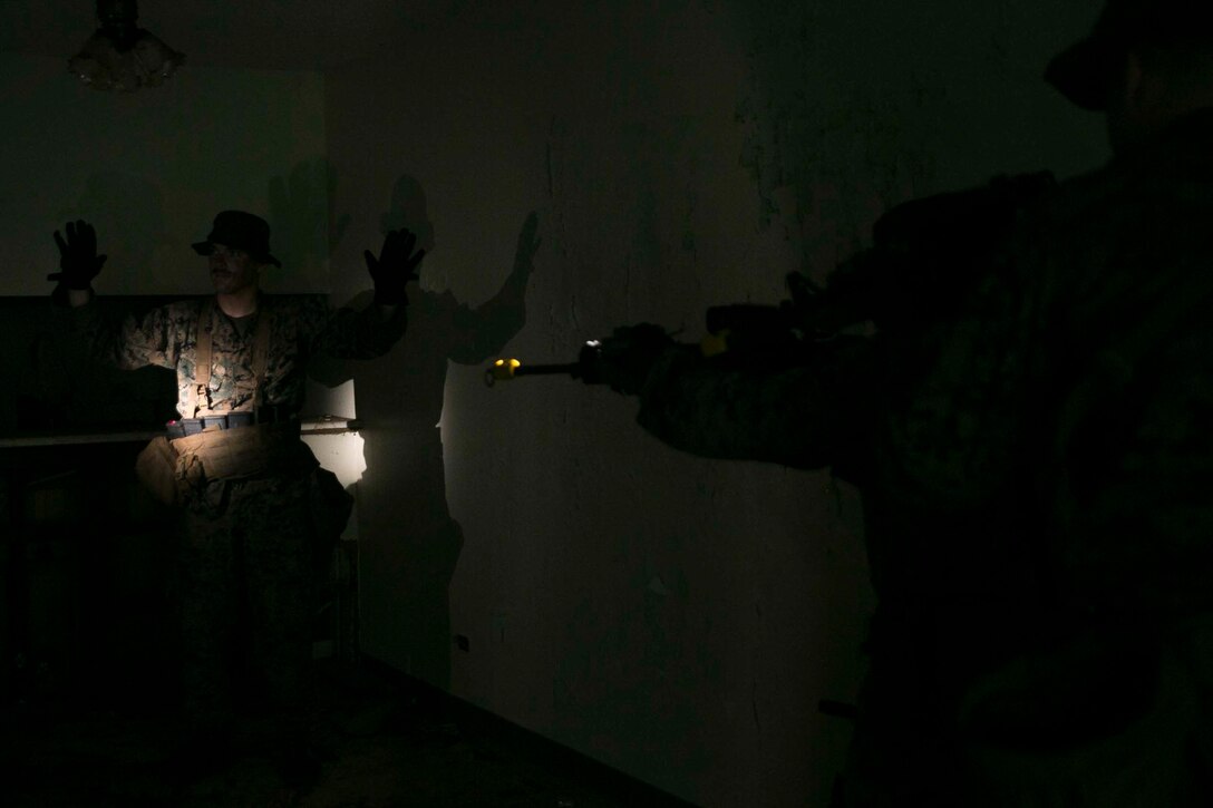 Marines with Battalion Landing Team, 3rd Battalion, 5th Marines, detain a role player while clearing a room during Military Operations in Urbanized Terrain (MOUT) training at Andersen South Air Force Base, Guam, August 30, 2017. Marines with BLT 3/5 train regularly in different environments to maintain their readiness as the Ground Combat Element of the 31st Marine Expeditionary Unit. The 31st MEU partners with the Navy's Amphibious Squadron 11 to form the Bonhomme Richard Expeditionary Strike Group, providing a cohesive blue-green team capable of accomplishing a variety of missions across the Indo-Asia-Pacific region. (U.S. Marine Corps photo by Cpl. Amaia Unanue/Released)