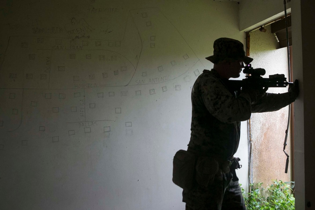 Sgt. Kristopher J. Hunt, an assistant squad leader with Battalion Landing Team, 3rd Battalion, 5th Marines, sets security during Military Operations in Urbanized Terrain (MOUT) training at Andersen South Air Force Base, Guam, August 30, 2017. Marines with BLT 3/5 train regularly in different environments to maintain their readiness as the Ground Combat Element of the 31st Marine Expeditionary Unit. The 31st MEU partners with the Navy's Amphibious Squadron 11 to form the Bonhomme Richard Expeditionary Strike Group, providing a cohesive blue-green team capable of accomplishing a variety of missions across the Indo-Asia-Pacific region. (U.S. Marine Corps photo by Cpl. Amaia Unanue/Released)