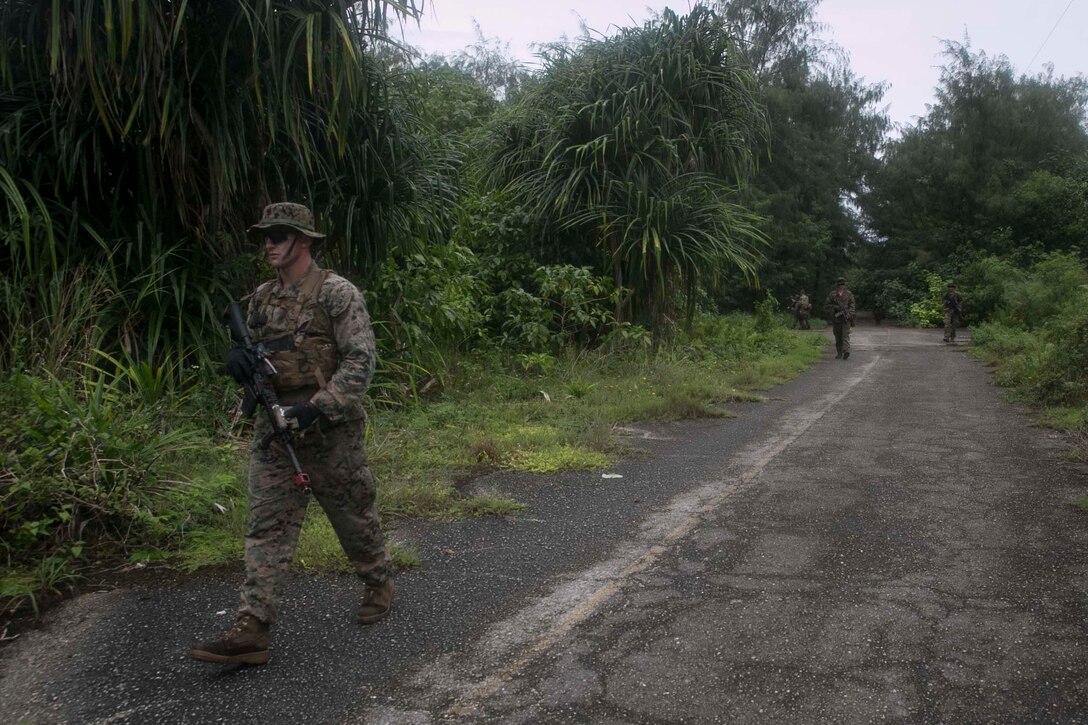Sgt. Tyler Michaud, a squad leader with India Company, Battalion Landing Team, 3rd Battalion, 5th Marines, leads a patrol during Military Operations in Urbanized Terrain (MOUT) training at Andersen South Air Force Base, Guam, August 30, 2017. Marines with BLT 3/5 train regularly in different environments to maintain their readiness as the Ground Combat Element of the 31st Marine Expeditionary Unit. The 31st MEU partners with the Navy's Amphibious Squadron 11 to form the Bonhomme Richard Expeditionary Strike Group, providing a cohesive blue-green team capable of accomplishing a variety of missions across the Indo-Asia-Pacific region. (U.S. Marine Corps photo by Cpl. Amaia Unanue/Released)