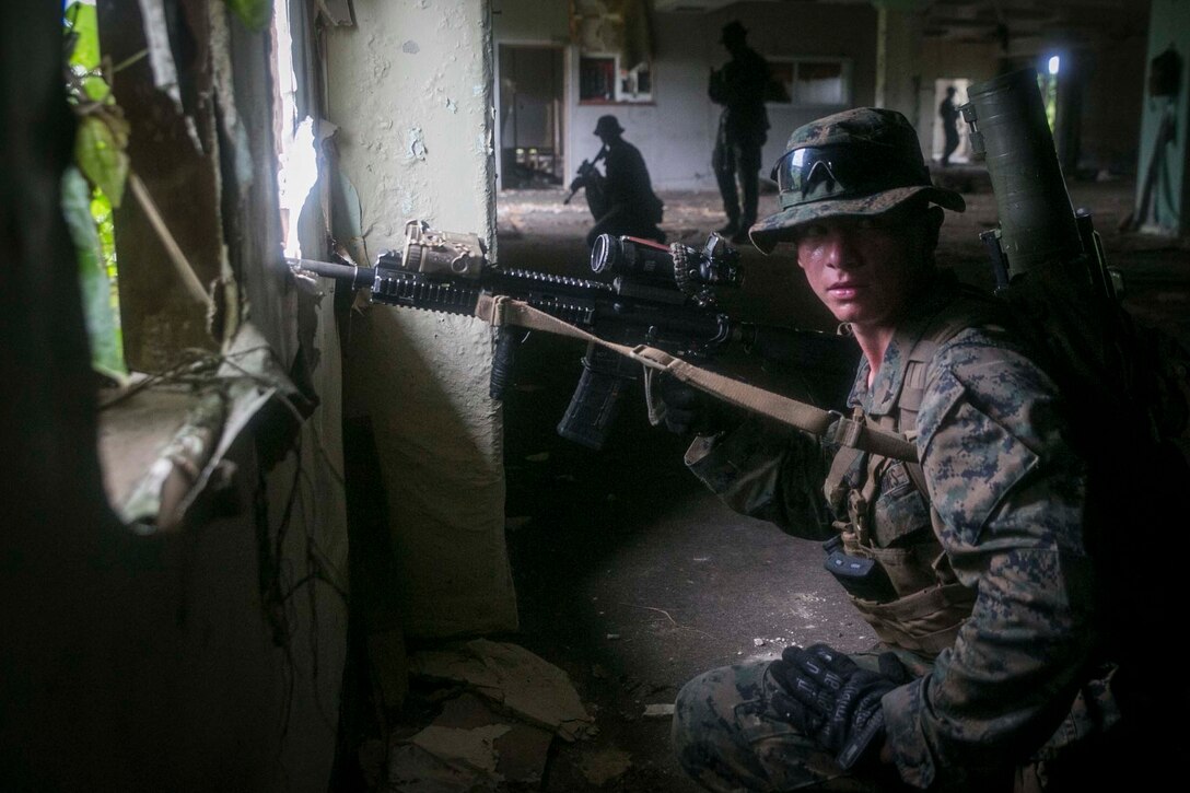 Lance Cpl. Cody L. Jowers, a rifleman with India Company, Battalion Landing Team, 3rd Battalion, 5th Marines, sets security during Military Operations in Urbanized Terrain (MOUT) training at Andersen South Air Force Base, Guam, August 30, 2017. Marines with BLT 3/5 train regularly in different environments to maintain their readiness as the Ground Combat Element of the 31st Marine Expeditionary Unit. The 31st MEU partners with the Navy's Amphibious Squadron 11 to form the Bonhomme Richard Expeditionary Strike Group, providing a cohesive blue-green team capable of accomplishing a variety of missions across the Indo-Asia-Pacific region. (U.S. Marine Corps photo by Cpl. Amaia Unanue/Released)