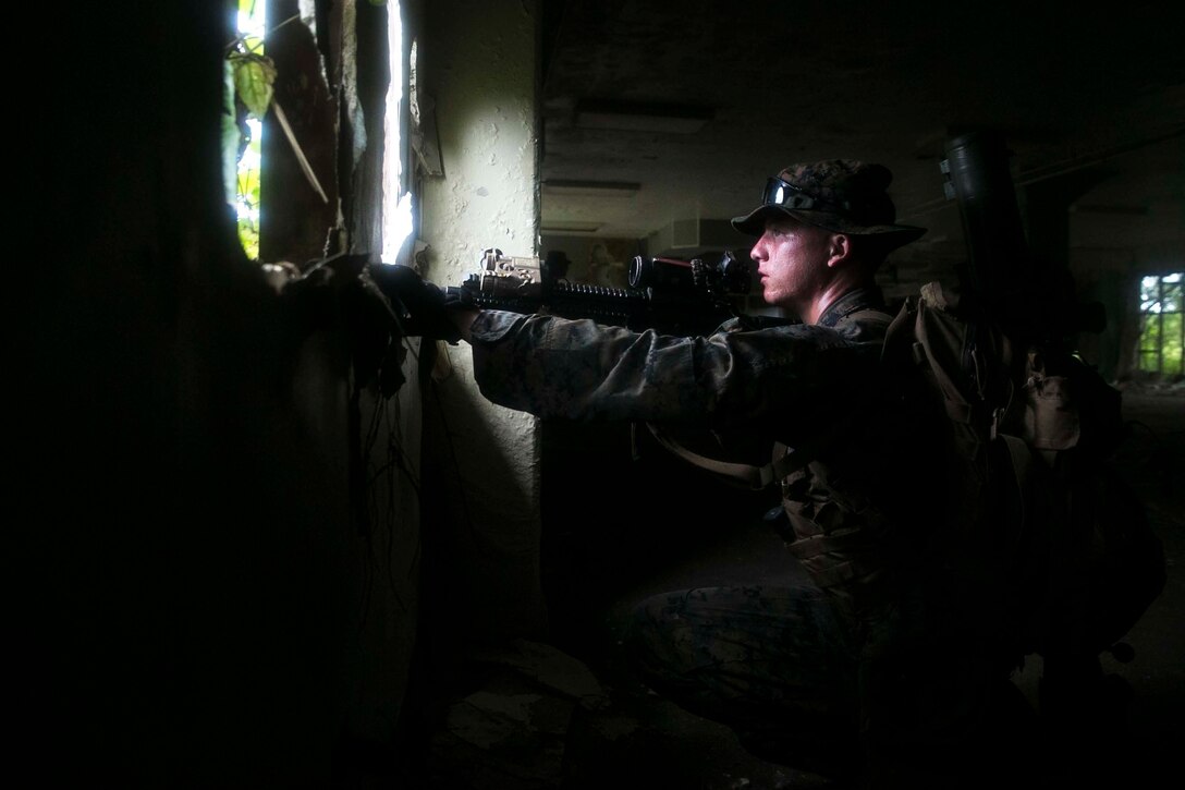 Lance Cpl. Cody L. Jowers, a rifleman with Battalion Landing Team, 3rd Battalion, 5th Marines, sets security during Military Operations in Urbanized Terrain (MOUT) training at South Andersen Air Force Base, Guam, August 30, 2017. Marines with BLT 3/5 train regularly in different environments to maintain their readiness as the Ground Combat Element of the 31st Marine Expeditionary Unit. The 31st MEU partners with the Navy's Amphibious Squadron 11 to form the Bonhomme Richard Expeditionary Strike Group, providing a cohesive blue-green team capable of accomplishing a variety of missions across the Indo-Asia-Pacific region. (U.S. Marine Corps photo by Cpl. Amaia Unanue/Released)