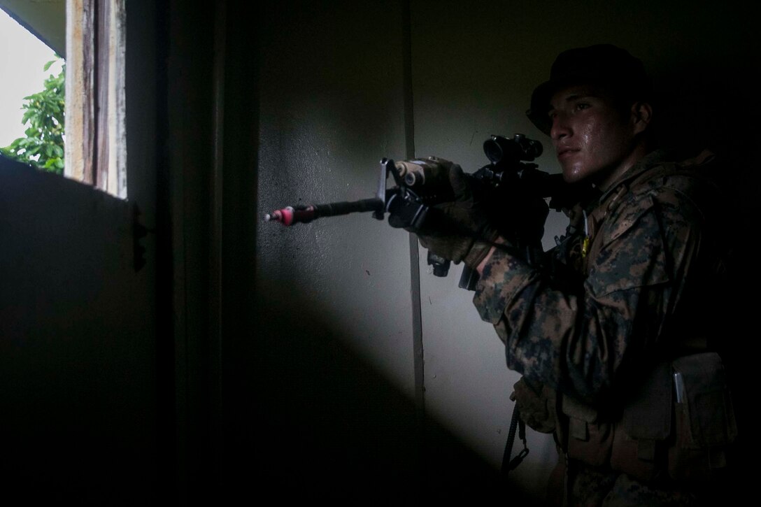 Lance Cpl. Edward Garcia, an Assault Amphibious Vehicle crewmember with Battalion Landing Team, 3rd Battalion, 5th Marines, sets security during Military Operations in Urbanized Terrain (MOUT) training at Andersen South Air Force Base, Guam, August 30, 2017. Marines with BLT 3/5 train regularly in different environments to maintain their readiness as the Ground Combat Element of the 31st Marine Expeditionary Unit. The 31st MEU partners with the Navy's Amphibious Squadron 11 to form the Bonhomme Richard Expeditionary Strike Group, providing a cohesive blue-green team capable of accomplishing a variety of missions across the Indo-Asia-Pacific region. (U.S. Marine Corps photo by Cpl. Amaia Unanue/Released)