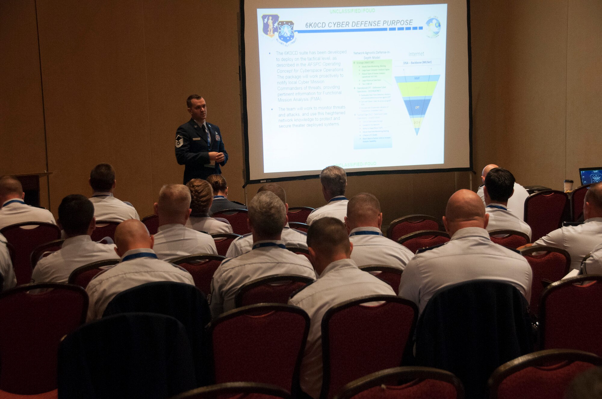 Airmen listen to a speaker at the Combat Communications conference.