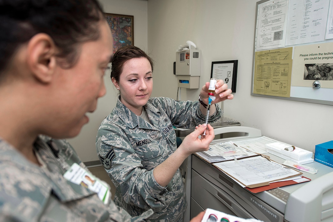 Air Force Senior Airman Taryn Mendoza, right, prepares a syringe at Misawa Air Base, Japan. DLA Troop Support’s Medical supply chain provides more than 25,000 pharmaceuticals to military healthcare providers around the world. Mendoza is a medical technician with the 35th Medical Operations Squadron.