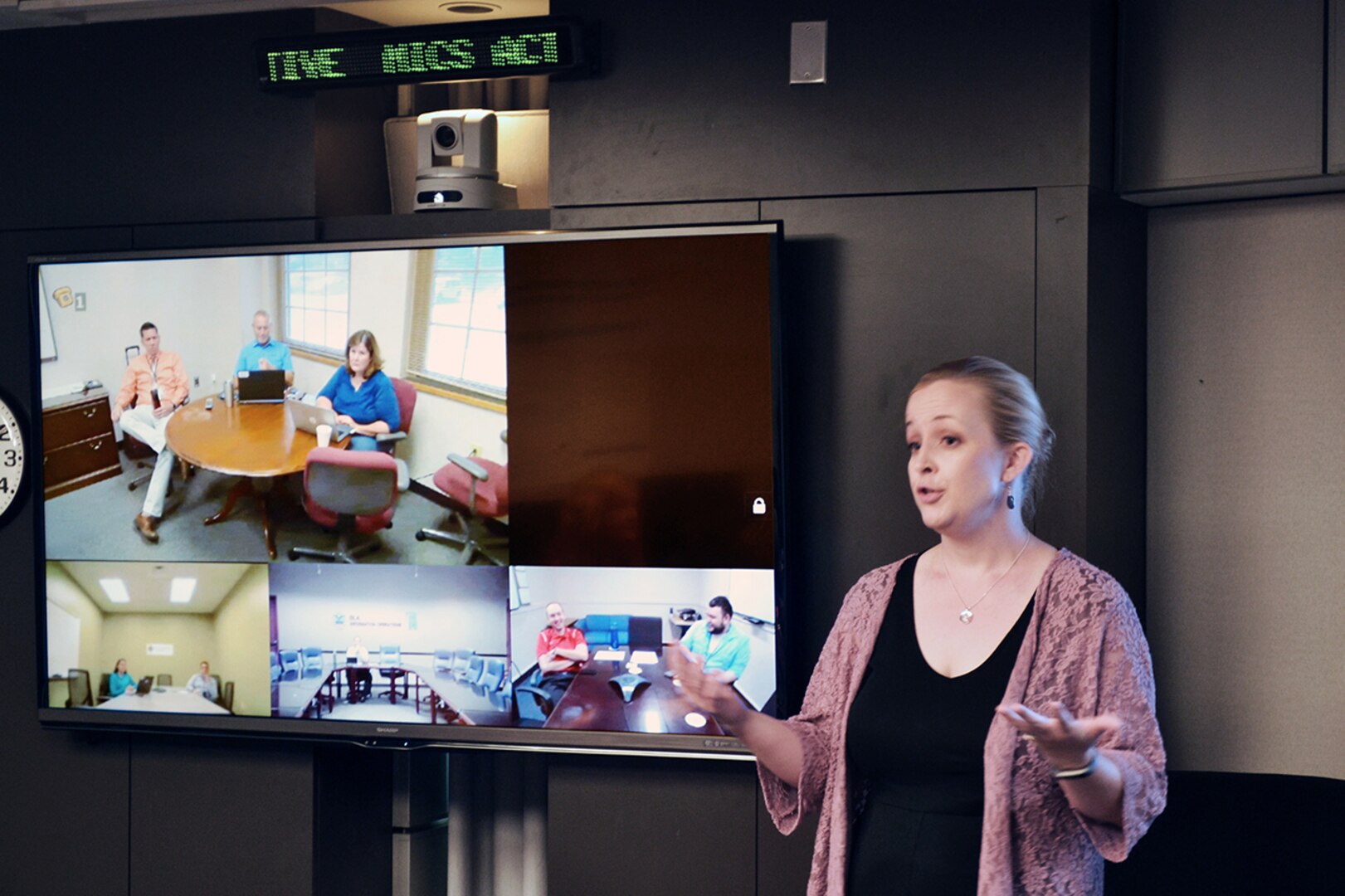 Sara Moore, right, explains the proposed benefits of her team’s project as the judging panel listens and asks questions.