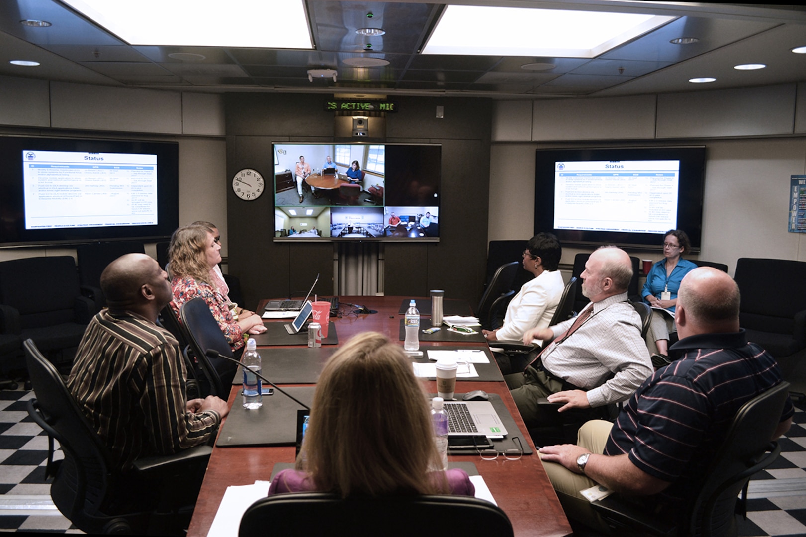 At Fort Belvoir, Virginia, senior leaders in DLA Information Operations listen as a team presents its project via video teleconference.