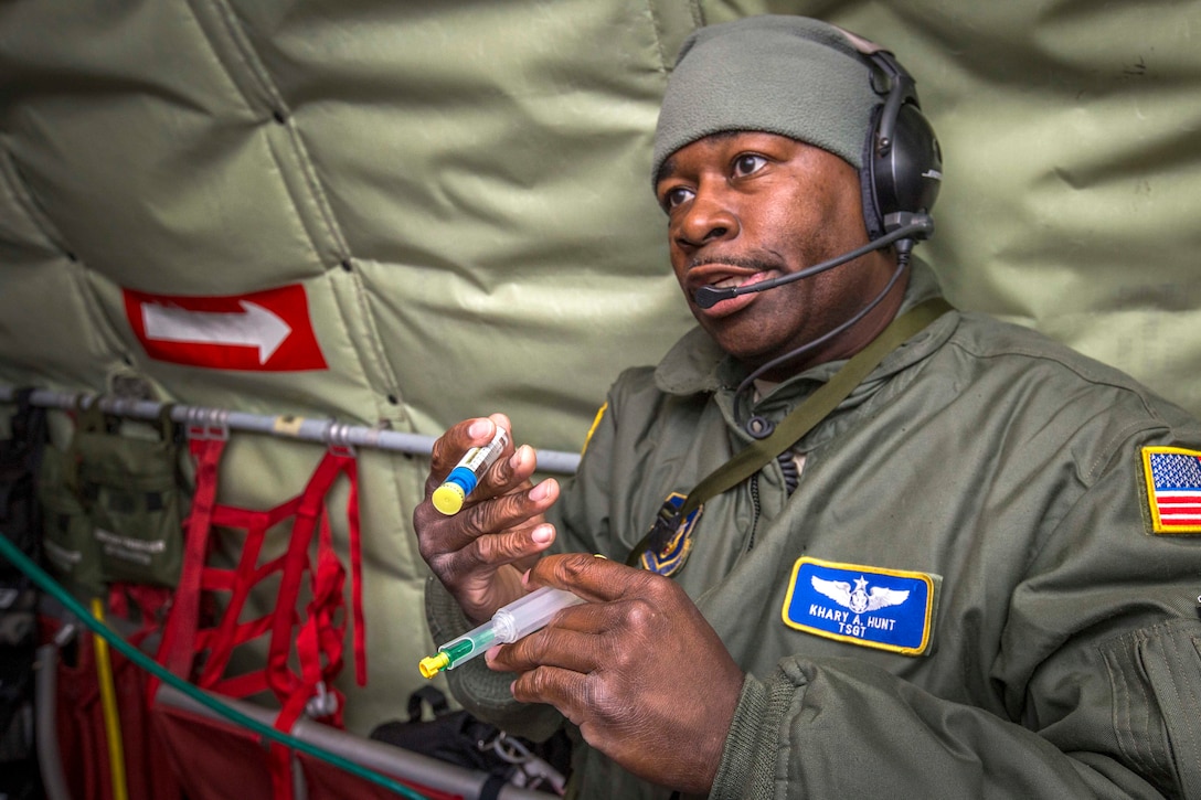 Tech. Sgt. Khary A. Hunt demonstrates how to assemble the components of epinephrine injection kit