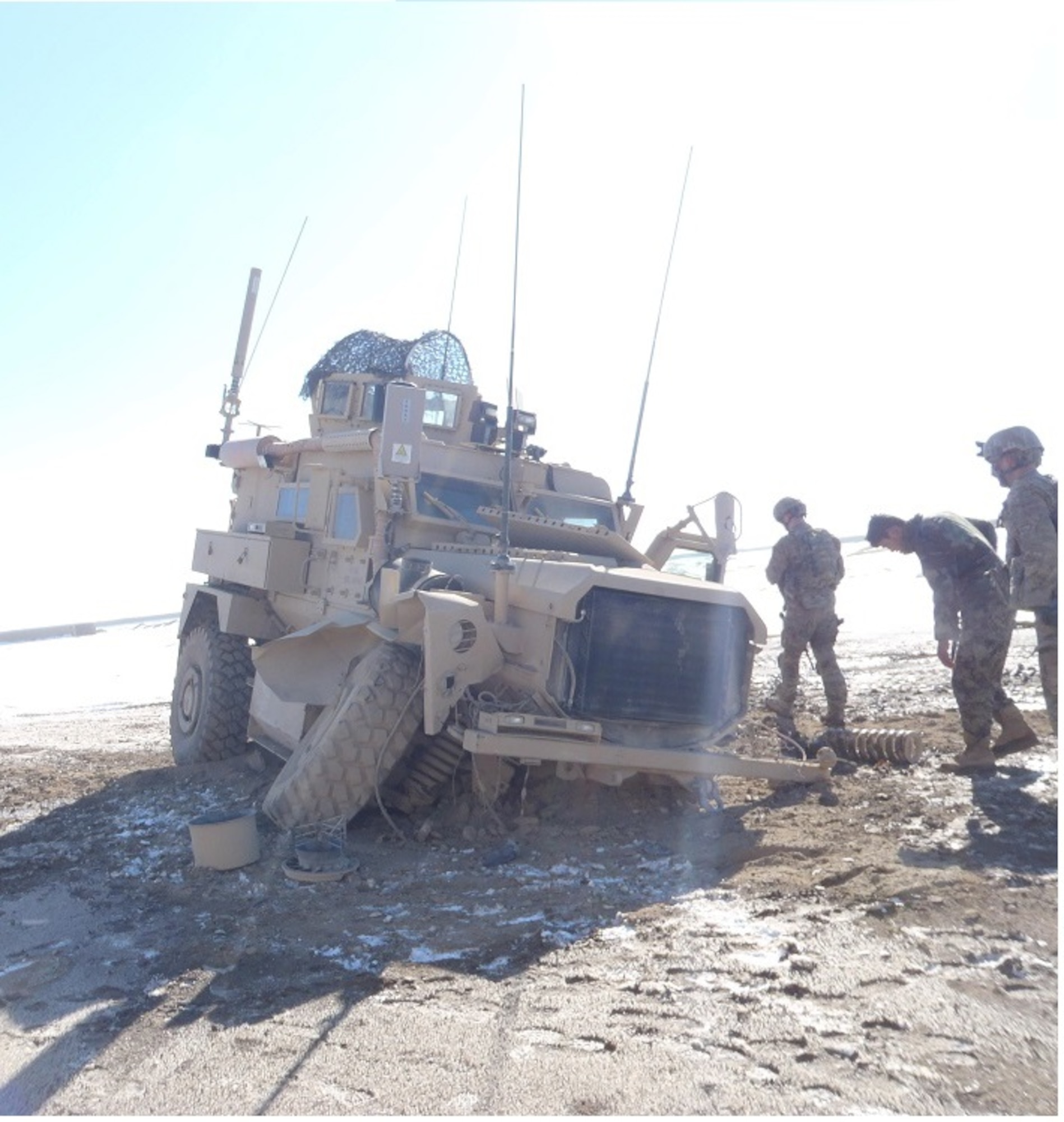 U.S. service members inspect the aftermath of vehicle U.S. Air Force Staff Sgt. Timothy Donnan, 633rd Civil Engineer Squadron Explosives Ordnance Disposal team lead, was in after it was hit by an Improvised Explosive Device in Afghanistan, Jan. 16, 2012. (courtesy photo)