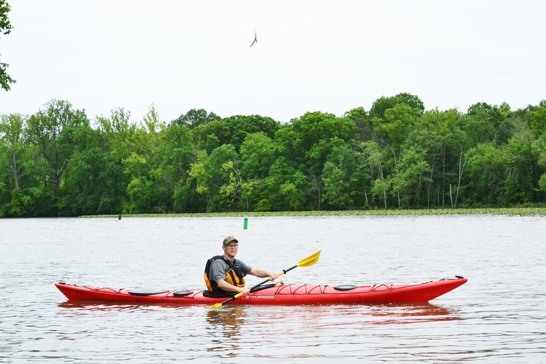 Army Col. Wil McCauley paddles his sea kayak out of Dogue Creek, a tributary of the Potomac River, on the way to his home in Maryland from Fort Belvoir, Virginia.
