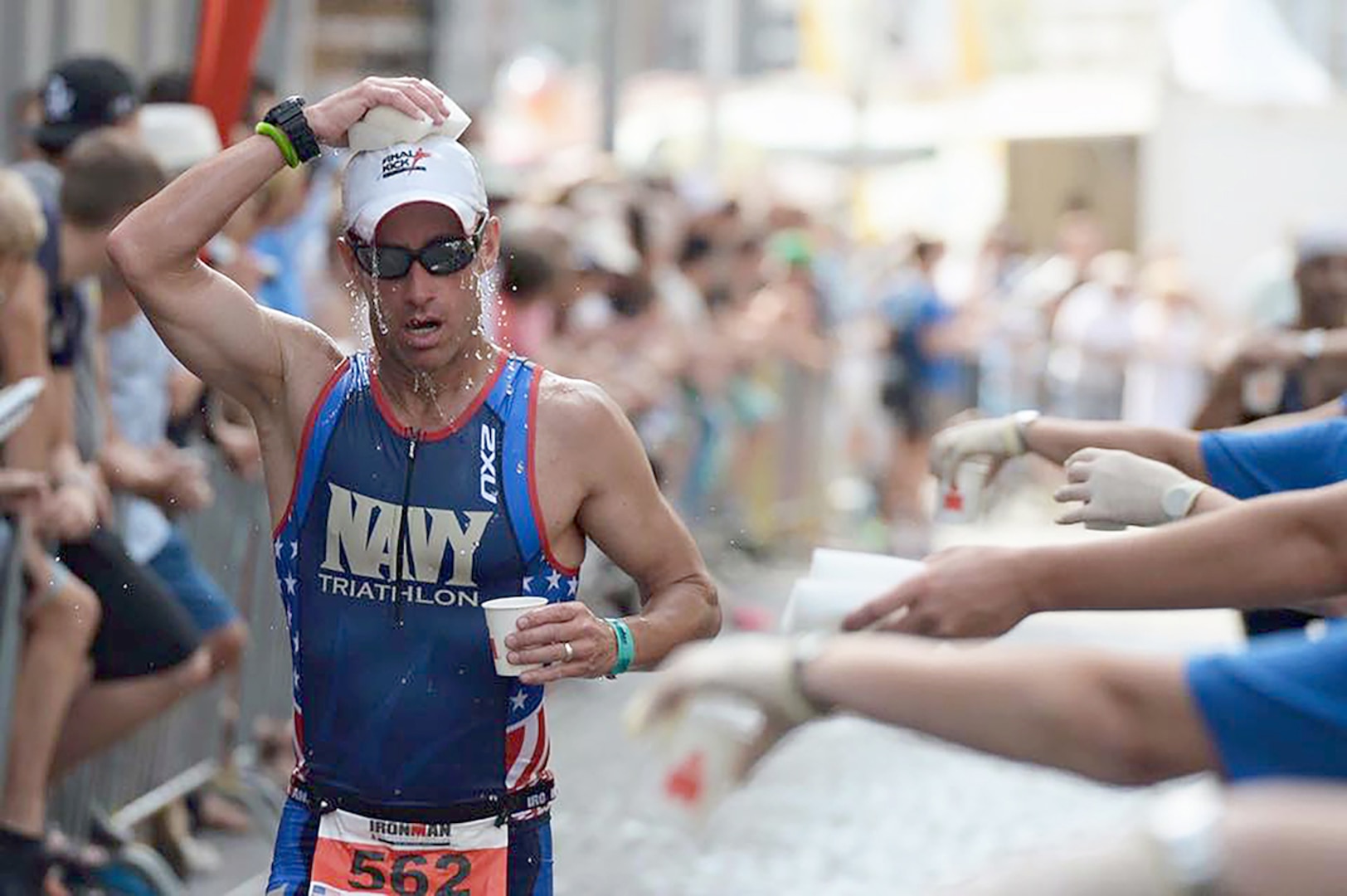 Navy Lt. Cmdr. Ryan Stickel wipes the sweat from his brow during an Ironman triathlon.