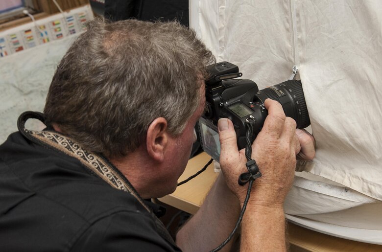Joel Sartore, a photographer for National Geographic, takes an image of a juvenile Northern Spotted Owl to add to the Photo Ark, Aug. 17, 2017, at the California Raptor Center, University of California, Davis.  Satore is founder of the Photo Ark Project, a groundbreaking effort to document species before they disappear. (U.S. Air Force photo by Heide Couch)