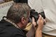 Joel Sartore, a photographer for National Geographic, takes an image of a juvenile Northern Spotted Owl to add to the Photo Ark, Aug. 17, 2017, at the California Raptor Center, University of California, Davis.  Satore is founder of the Photo Ark Project, a groundbreaking effort to document species before they disappear. (U.S. Air Force photo by Heide Couch)
