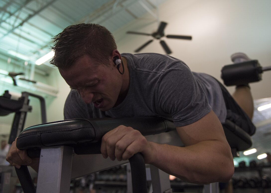U.S. Air Force 1st Lt. James LaCoste, 633rd Force Support Squadron chief career development element, performs a lying leg curl at Joint Base Langley-Eustis, Va., July 20, 2017. LaCoste has been weightlifting for more than 13 years and credits his foundation in bodybuilding to his father. (U.S. Air Force photo by Staff Sgt. J.D. Strong II)