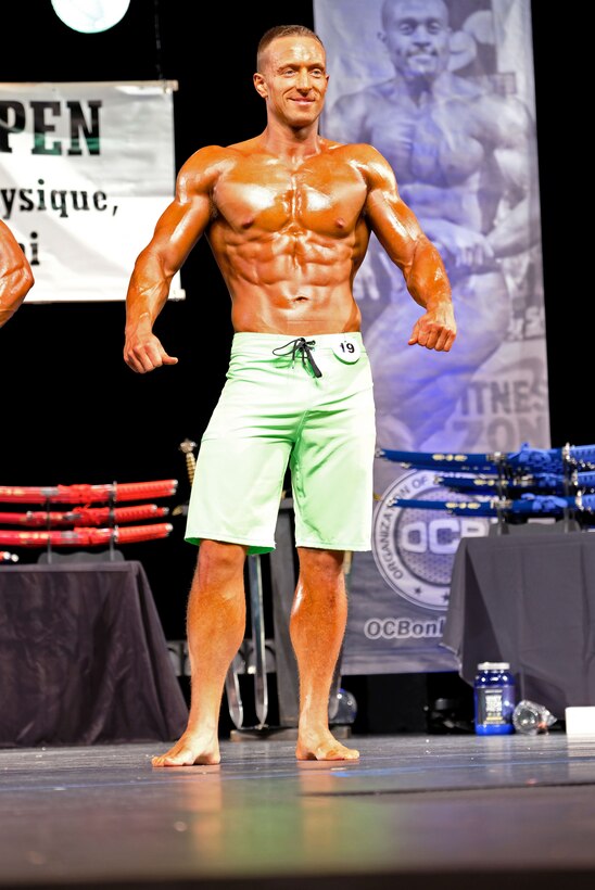 U.S. Air Force 1st Lt. James LaCoste, 633rd Force Support Squadron chief career development element, performs a muscularity pose during the Organization of Competition Bodies' Colonial Open bodybuilding competition at the Williamsburg Crosswalk Church, Williamsburg, Va., July 1, 2017.  The Colonial Opener was LaCoste's first competition and he received third place. (Courtesy photo)