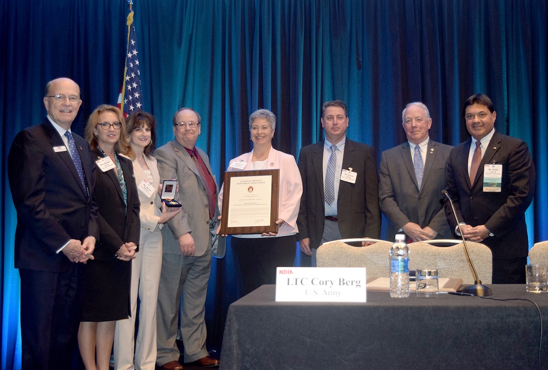 Members of DLA Land and Maritime’s Strategic Acquisition Programs Directorate receive the 2017 Red Ball Express Award from the National Defense Industrial Association in a May 2017 conference, for their critical support of the Medium Tactical Vehicle Replacement logistics program.