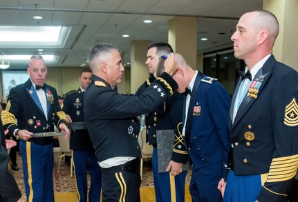 Maj. James Crawford, 67th Cyberspace Operations Group, receives the 2017 AFCEA Saint Isidore Army Cyber Award from from Lt. Gen. Paul Nakasone, Commanding General of U.S. Army Cyber Command, at the Army Cyber Ball Aug. 19, Fort Belvoir, Va. Crawford was the only Airman to win this award, which is given to those who make significant contributions to the promotion of the Army Cyber mission.